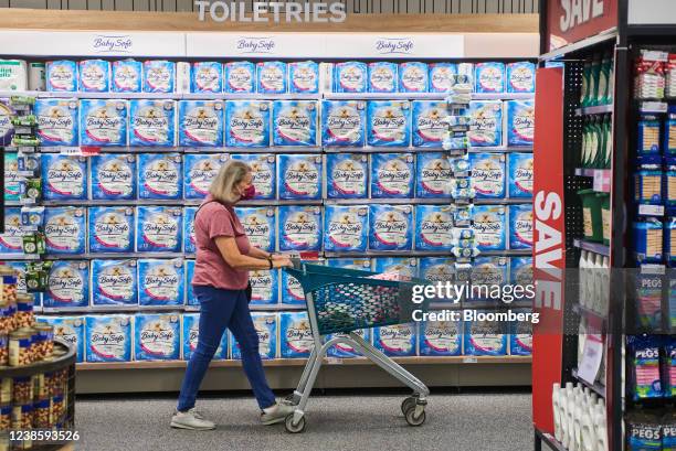 Shopper wearing a protective face mask wheels a shopping cart by toilet tissue inside a Checkers supermarket, operated by Shoprite Holdings Ltd., in...