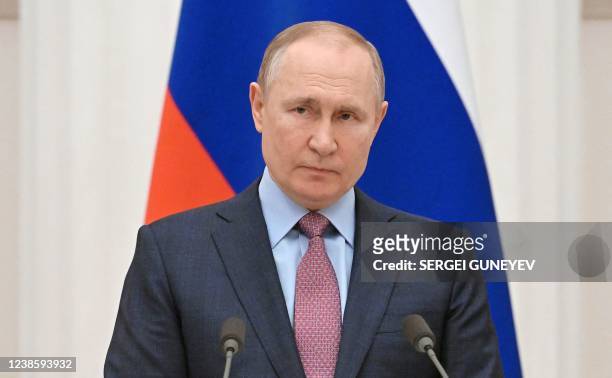 Russia's President Vladimir Putin attends a press conference with his Belarus counterpart, following their talks at the Kremlin in Moscow on February...