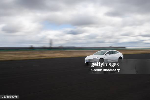 Driver tests Michelin Pilot Sport 4 tires on a Tesla Inc. Model 3 at a test track in the Michelin Ladoux site in Clermont Ferrand, France, on...