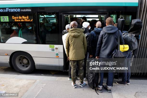 Commuters take a bus to go to the other railway stations from Gare de Montparnasse railway station in Paris on February 18, 2022 as employees of the...
