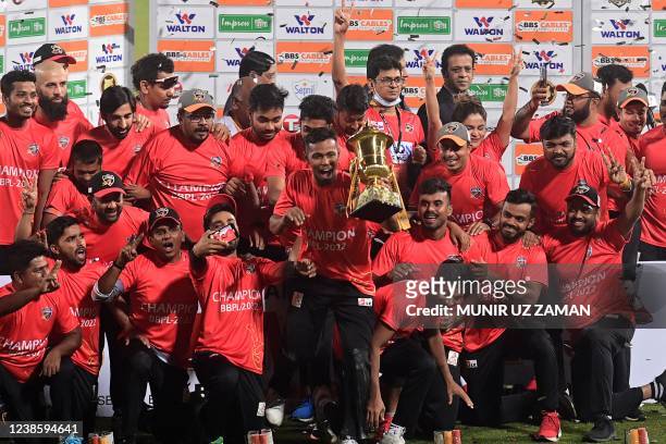 Comilla Victorians' cricketers pose with the tournament trophy after winning the Bangladesh Premier League Twenty20 final cricket match between...