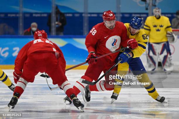 Anton Slepyshev of Russia and Philip Holm of Sweden im Zweikampf at men's ice hockey playoff semifinal match between ROC and Sweden during the...