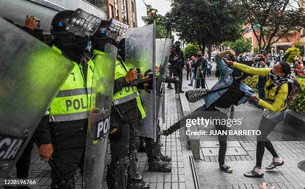 An anti-fascism protester throw stones over riot police in front of an hotel where the 1st Regional Meeting 'For Democracy and Freedoms' organised by...