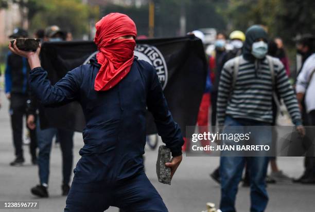 An anti-fascism protester throws a stone at riot police in front of an hotel where the 1st Regional Meeting 'For Democracy and Freedoms' organised by...