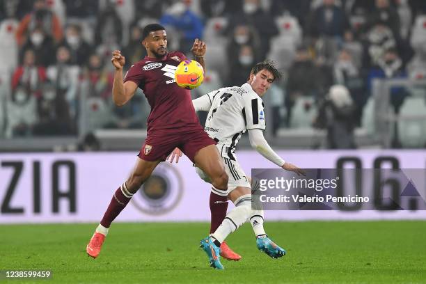 Dusan Vlahovic of Juventus is challenged by Gleison Bremer of Torino FC during the Serie A match between Juventus and Torino FC at Allianz Stadium on...
