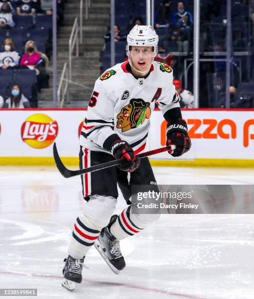 Connor Murphy of the Chicago Blackhawks keeps an eye on the play during third period action against the Winnipeg Jets at Canada Life Centre on...