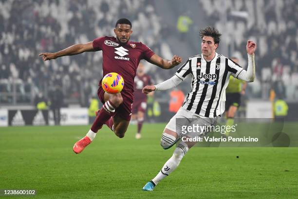 Gleison Bremer of Torino FC in action against Dusan Vlahovic of Juventus during the Serie A match between Juventus and Torino FC at Allianz Stadium...