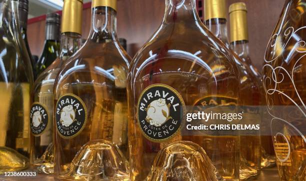 Bottles of Chateau Miraval Cotes de Provence rose wine are displayed on a shelf in a Los Angeles store on February 18, 2022. - Brad Pitt is suing...