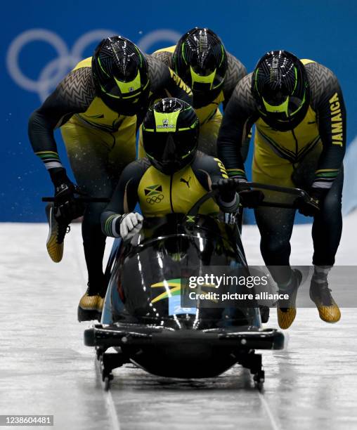 February 2022, China, Yanqing: Bobsleigh, Olympics, four-man bobsleigh, men, heat 2, at the National Sliding Centre, Jamaica's Shanwayne Stephens...
