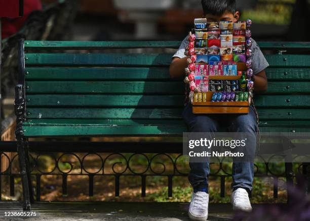 Young street vendor is taking a break in Merida city center. On Friday, February 18 in Merida, Yucatan, Mexico.