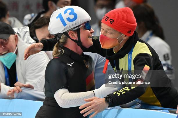 February 2022, China, Peking: Olympics, speed skating, mass start, women, final, National Speed Skating Oval, Claudia Pechstein of Germany hugs coach...