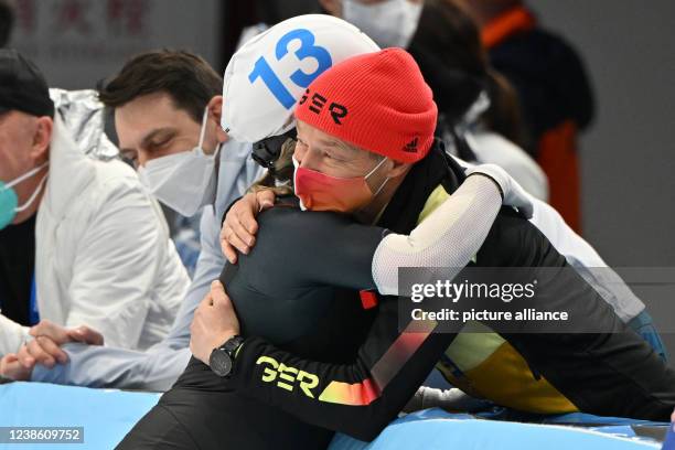February 2022, China, Peking: Olympics, speed skating, mass start, women, final, National Speed Skating Oval, Claudia Pechstein of Germany hugs coach...
