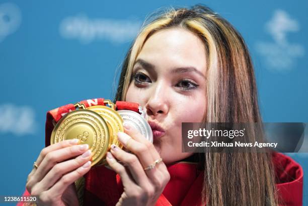 Gold medalist Chinese athlete Gu Ailing kisses her medals after the awarding ceremony of freestyle skiing women's freeski halfpipe at Zhangjiakou...