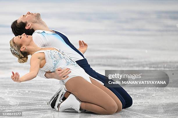 Canada's Kirsten Moore-Towers and Canada's Michael Marinaro compete in the pair skating free skating of the figure skating event during the Beijing...
