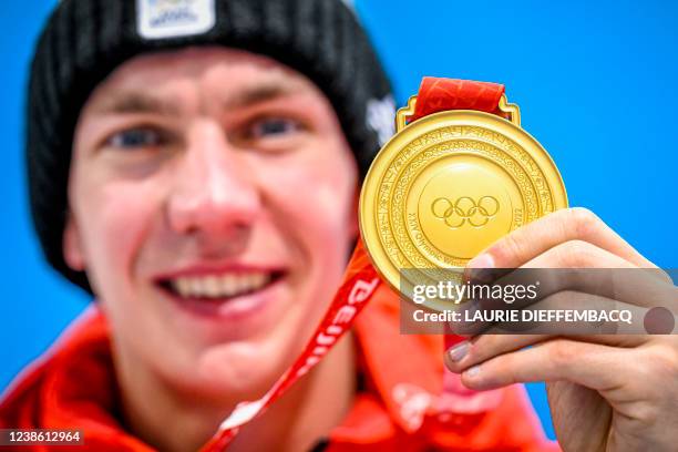 Belgian speed skater Bart Swings poses with his gold medal for the photographer after the medal ceremony of the men's mass start speed skating event...