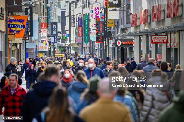 People walk on a pedestrian shopping street in the city center during the Omicron wave of the novel coronavirus variant on February 19, 2022 in...
