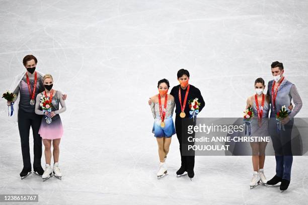 Silver medallists Russia's Evgenia Tarasova and Russia's Vladimir Morozov, gold medallists China's Sui Wenjing and China's Han Cong and bronze...