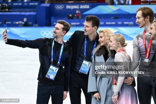 Russian coach Eteri Tutberidze , silver medallists Russia's Evgenia Tarasova and Russia's Vladimir Morozov pose for a photo during the venue ceremony...