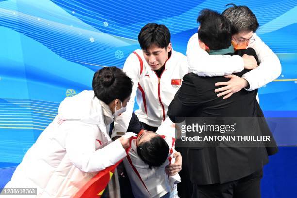 This picture taken with a robotic camera shows China's Sui Wenjing apparently overcome by emotion after winning the pairs skating free skating gold...