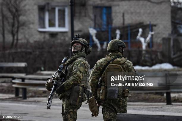 Ukrainian troops patrol in the town of Novoluhanske, eastern Ukraine, on February 19, 2022. - Ukraine's army said Saturday that two of its soldiers...