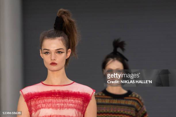 Models present creations by British designer Molly Goddard during the catwalk show for the Autumn/Winter 2022 collection fashion show on the second...