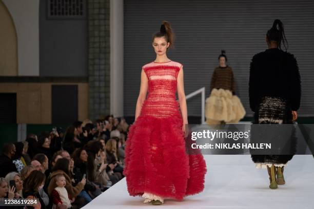 Models present creations by British designer Molly Goddard during the catwalk show for the Autumn/Winter 2022 collection fashion show on the second...