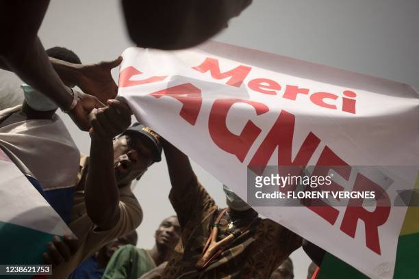 Protesters holds a banner reading "Thank you Wagner", the name of the Russian private security firm present in Mali, during a demonstration organised...