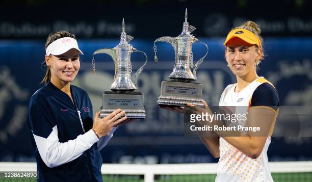 Elise Mertens of Belgium and Veronika Kudermetova of Russia pose with their champions trophies after defeating Jelena Ostapenko of Latvia and...