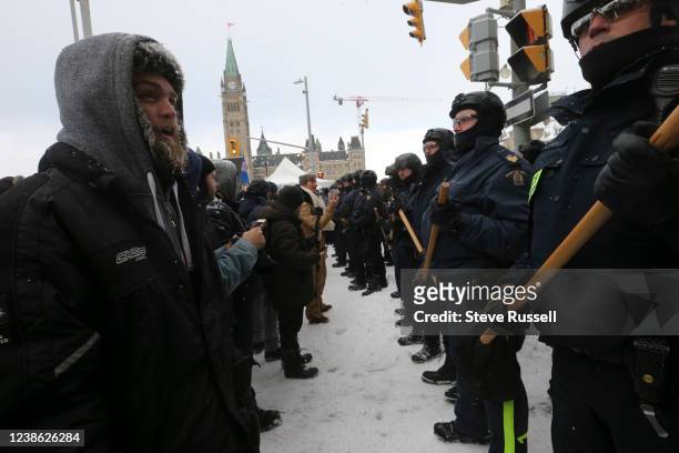Police form a line as they clear protesters from the intersection of Wellington and Metcalfe. Protesters from the "Freedom Convoy" in Ottawa are...