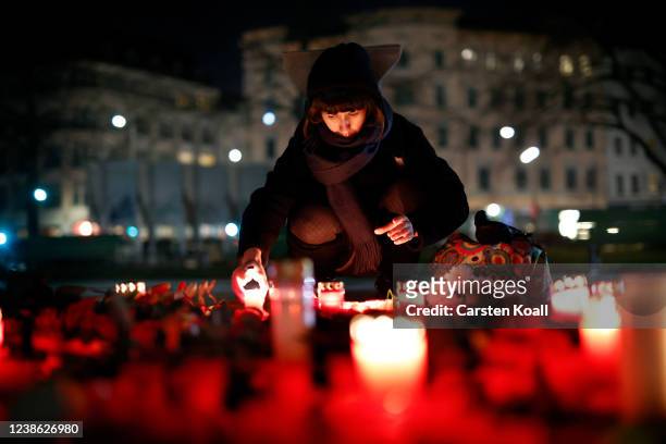 Woman lights candles to commemorate the 2nd anniversary of the Hanau shootings on February 19, 2022 in the Kreuzberg district of Berlin, Germany. On...