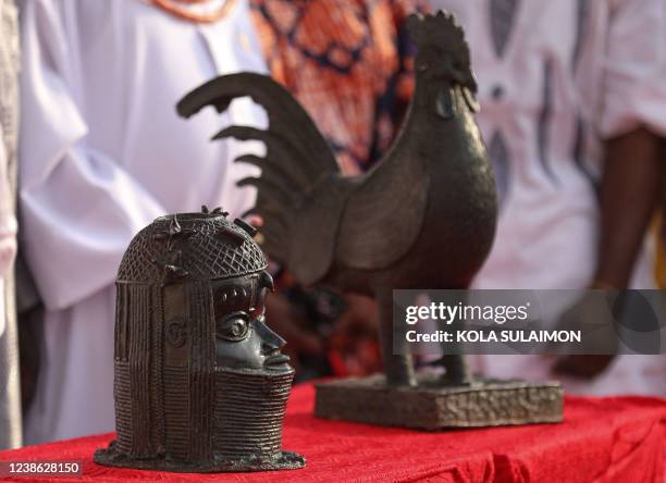 The two artifacts, which include a bronze cockerel and a bust that were looted from Nigeria over 125 years ago by the British military force, are...