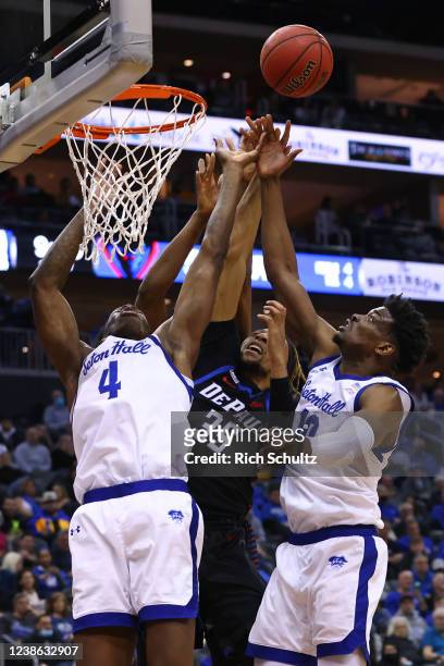 Brandon Johnson of the DePaul Blue Demons battles Tyrese Samuel and Alexis Yetna of the Seton Hall Pirates for a rebound during the first half of a...