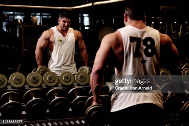 Chris Kavvalos performs a shrug exercise during a workout at City Gym on May 24, 2020 in Sydney, Australia. IFFBB body builder Chris Kavvalos has...