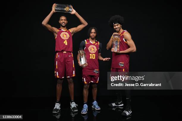 Evan Mobley, Darius Garland and Jarrett Allen of the Cleveland Cavaliers pose for a portrait with the trophy after winning the Taco Bell Skills...