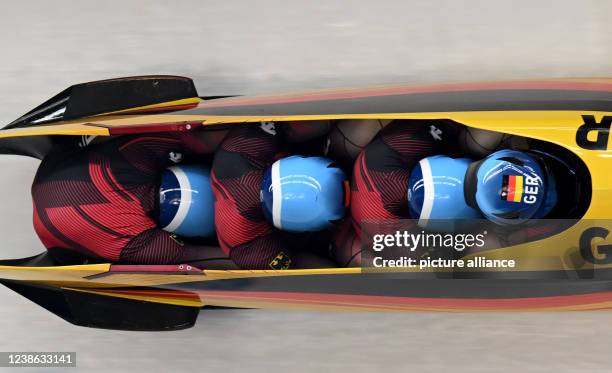 February 2022, China, Yanqing: Olympics, bobsleigh, four-man bobsleigh, heat 3, at Yanqing National Sliding Centre, bobsleigh pilot Johannes Lochner...