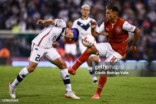Lucas Gonzalez of Independiente fights for the ball with Tomas Guidara of Velez Sarsfield during a match between Velez Sarsfield and Independiente as...