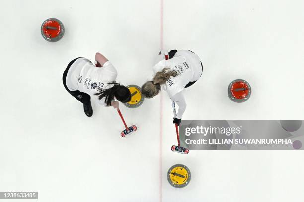 This overview shows Britain's Hailey Duff and Britain's Vicky Wright sweeping during the women's gold medal game of the Beijing 2022 Winter Olympic...