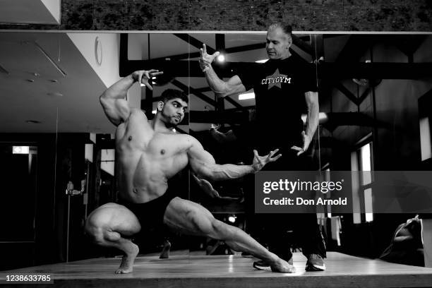 Chris Kavvalos practices posing manoeuvres under the watchful eye of PT Paul Haslam during a workout at City Gym on May 24, 2020 in Sydney,...