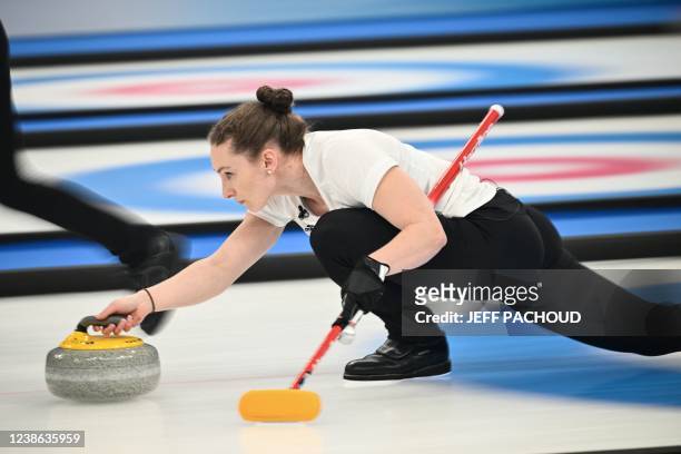 Britain's Vicky Wright curls the stone during the women's gold medal game of the Beijing 2022 Winter Olympic Games curling competition between Japan...
