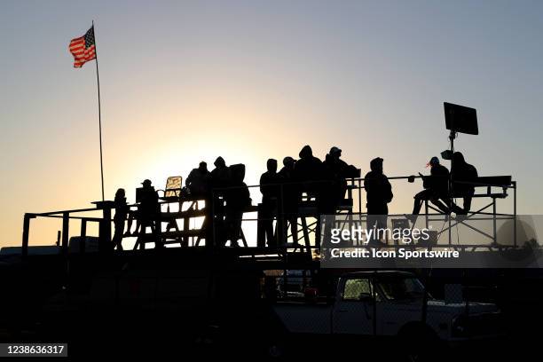 Fans are silhouetted as the sun begins to set during the running of the NASCAR Xfinity Series Beef,It's whats for Dinner 300 on February 19, 2022 at...