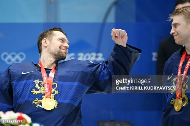 Finland's goaltender Harri Sateri poses with his gold medal after winning the men's gold medal match of the Beijing 2022 Winter Olympic Games ice...