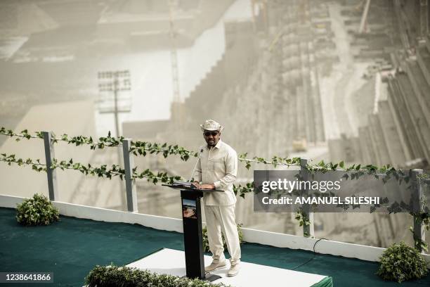 Ethiopia's Prime Minister Abiy Ahmed speaks during the first power generation ceremony at the site of the Grand Ethiopian Renaissance Dam in Guba,...