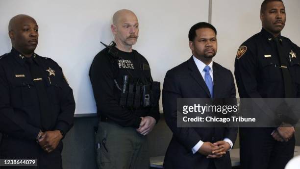 Aurora, Illinois, police officers and Aurora mayor Richard Irvin, second from right, during a news conference after a 2018 shooting incident in the...