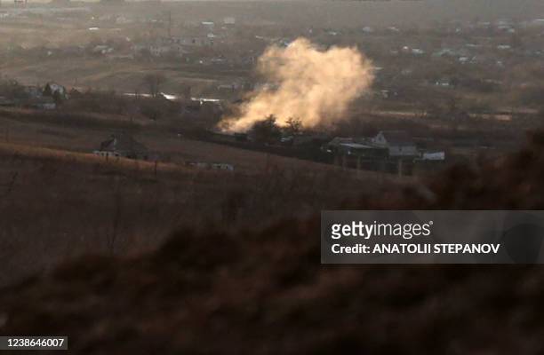 Photograph taken on February 19 shows smoke rising from an explosion after a shelling in Novohnativka village, Donetsk region, not far from position...