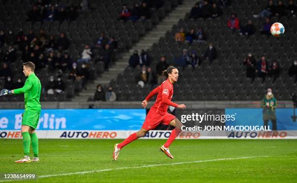 Leipzig's Danish forward Yussuf Poulsen runs past Hertha Berlin's German goalkeeper Alexander Schwolow before scoring the 6-1 goal during the German...