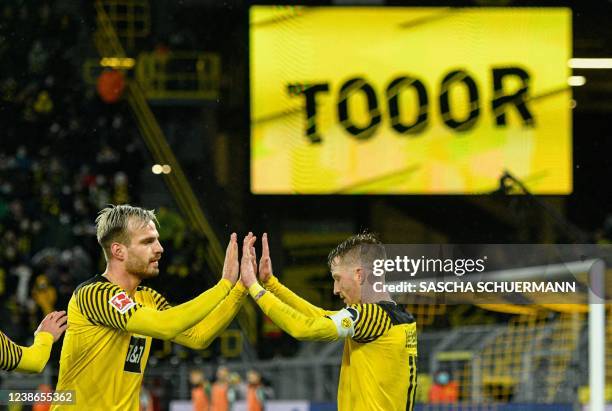 Dortmund's German forward Marco Reus celebrates scoring the 5-0 goal with Dortmund's Croatian defender Marin Pongracic during the German first...