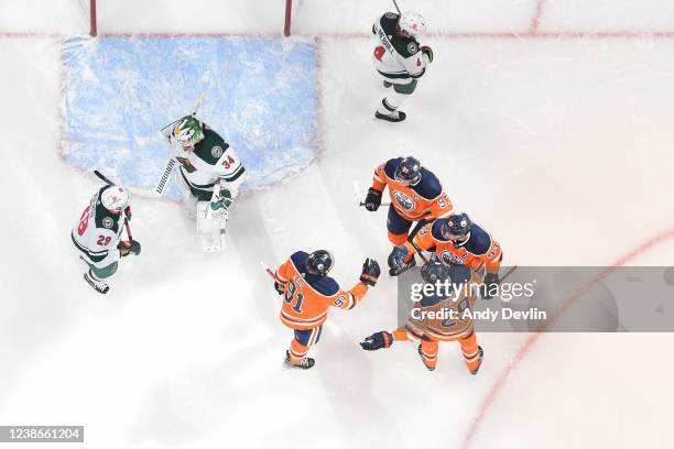 Evander Kane, Connor McDavid, Ryan Nugent-Hopkins and Leon Draisaitl of the Edmonton Oilers celebrate after a goal during the game against the...