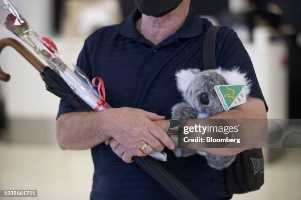 Man with a stuffed koala toy and flowers at the arrival hall at the international terminal of Sydney Airport in Sydney, Australia, on Monday, Feb....