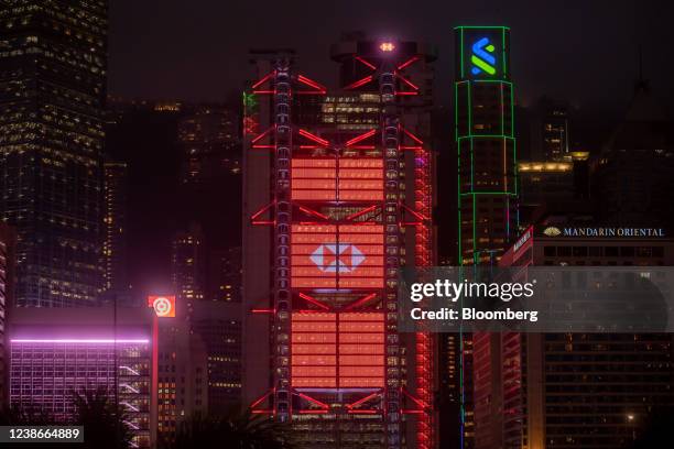 The illuminated HSBC Holdings Plc headquarters, center, at night in Hong Kong, China, on Friday, Feb. 18, 2022. HSBC is scheduled to release earnings...