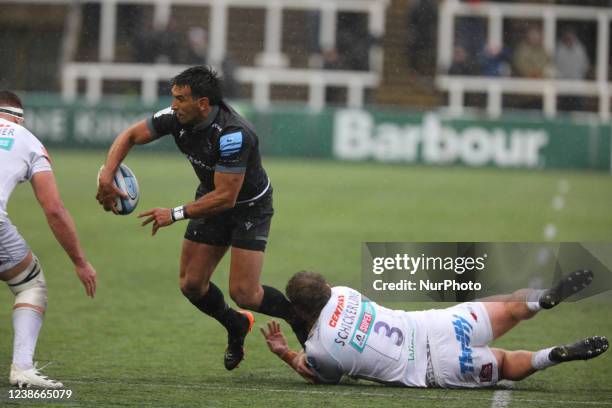 Matias Orlando of Newcastle Falcons is half tackled by Patrick Schickerling of Exeter Chiefs during the Gallagher Premiership match between Newcastle...